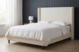 Conversano bed against dark charcoal-blue vertical panelling in a Seattle apartment bedroom with a pale oak floor