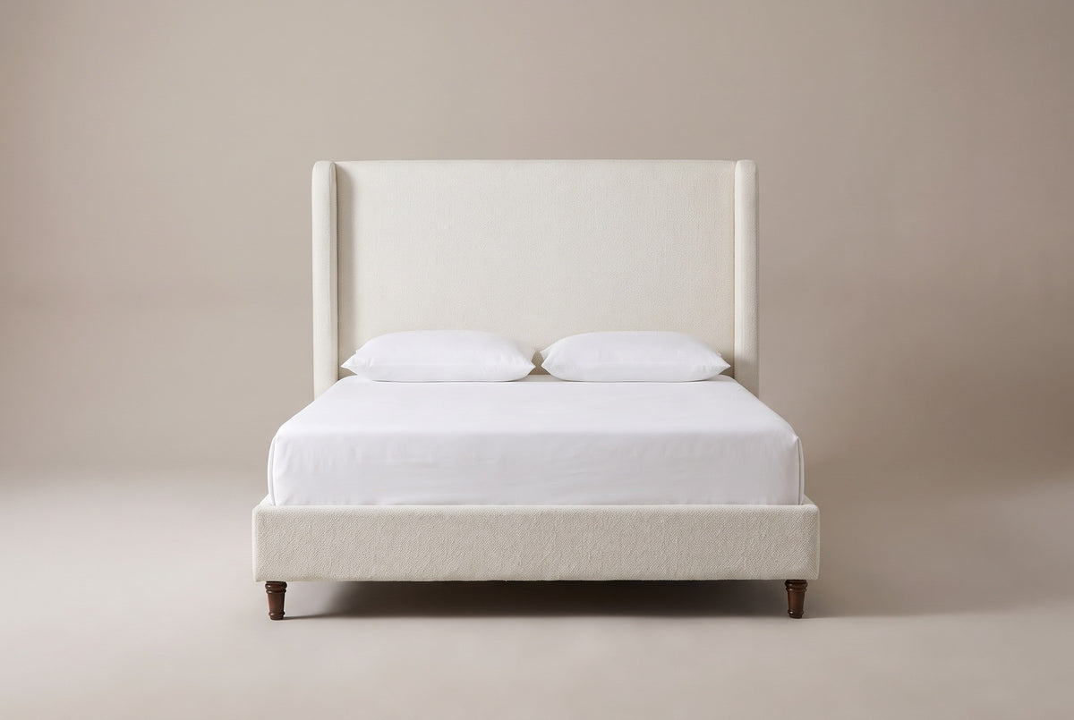 Conversano bed in cream white boucle with a white mattress and pillows (not included), front view