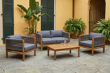 Corleone acacia conversation set in a walled courtyard with an ochre plaster wall, green shutters, banana palms and grey slate flagstones (carafe and glasses not included)