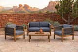 Corleone acacia conversation set on a sandstone terrace at golden hour, a red stacked-stone wall, agaves and red rock buttes behind (tray and jug not included)