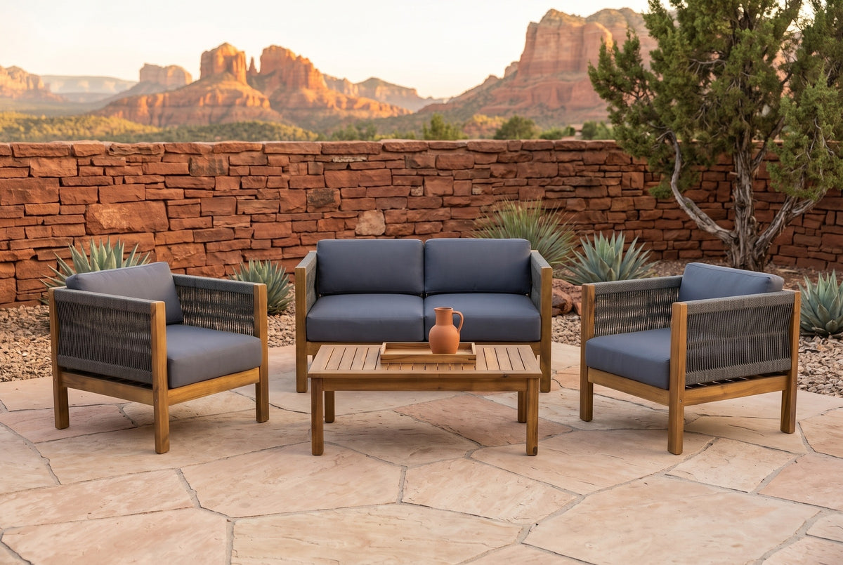 Corleone acacia conversation set on a sandstone terrace at golden hour, a red stacked-stone wall, agaves and red rock buttes behind (tray and jug not included)
