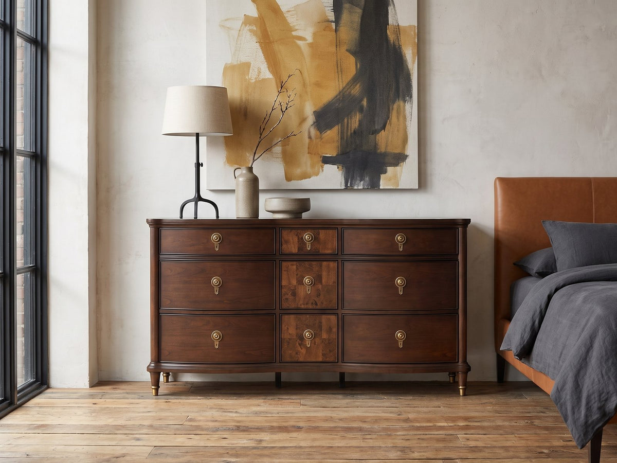 Cormons 66-Inch Dark Cherry and Burl 9-Drawer Dresser against a plaster wall in an industrial loft bedroom