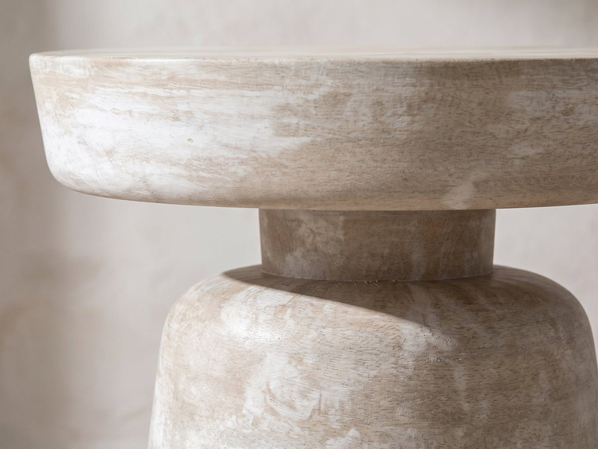 Close-up of the Craco Whitewashed Mango Pedestal Side Table: the thick top disc on its narrow collar over the cone base