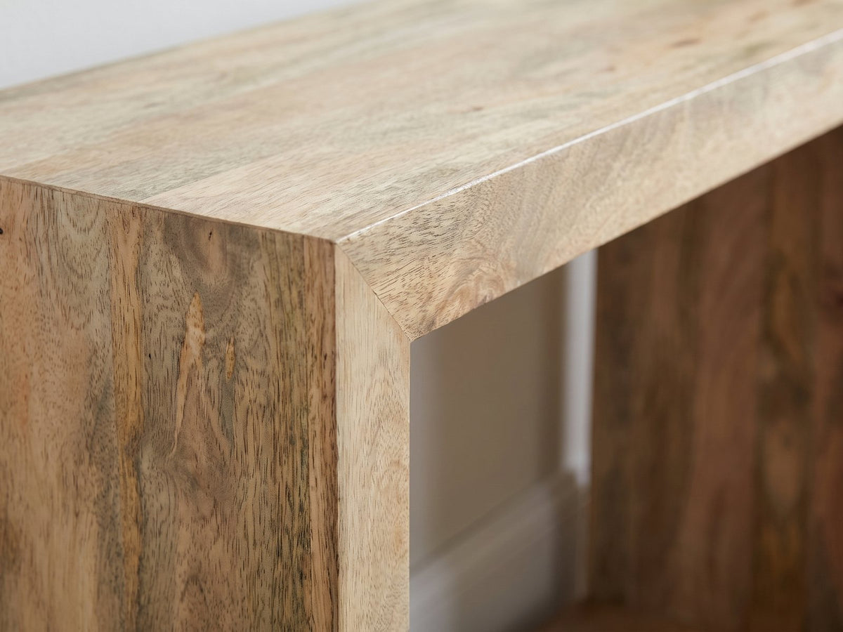 Close-up of the Crispiano Mango Wood Open Frame Console Table: the mitred corner where the mango top meets an end panel