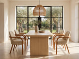 Cropani 69-Inch Rectangular Fluted Dining Set with 4 Arm Chairs in a sunlit villa dining area with olive trees outside
