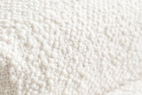 Close-up of the white boucle on the Cupello platform bed: soft round loops on a woven ground