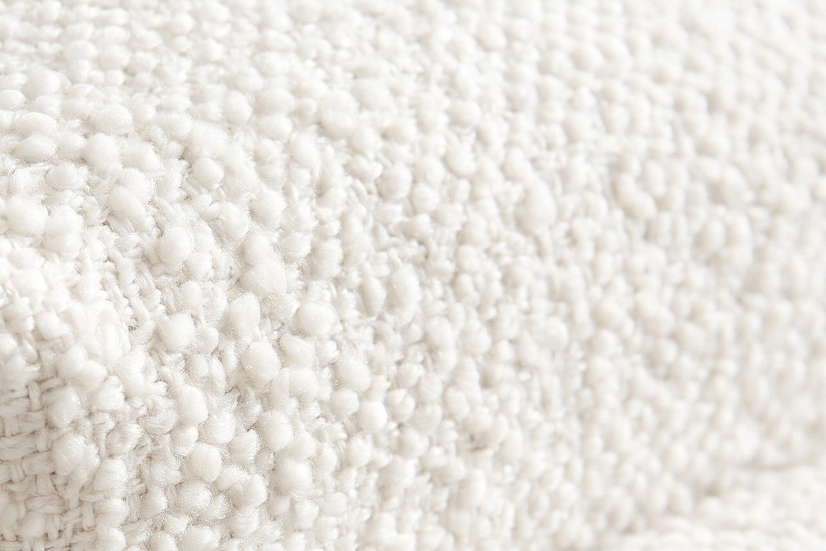 Close-up of the white boucle on the Cupello platform bed: soft round loops on a woven ground