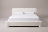 Cupello platform bed in white boucle with a white mattress and pillows (not included), front view
