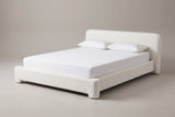 The Cupello platform bed in white boucle with a white mattress and pillows (not included), three-quarter view on a light studio backdrop