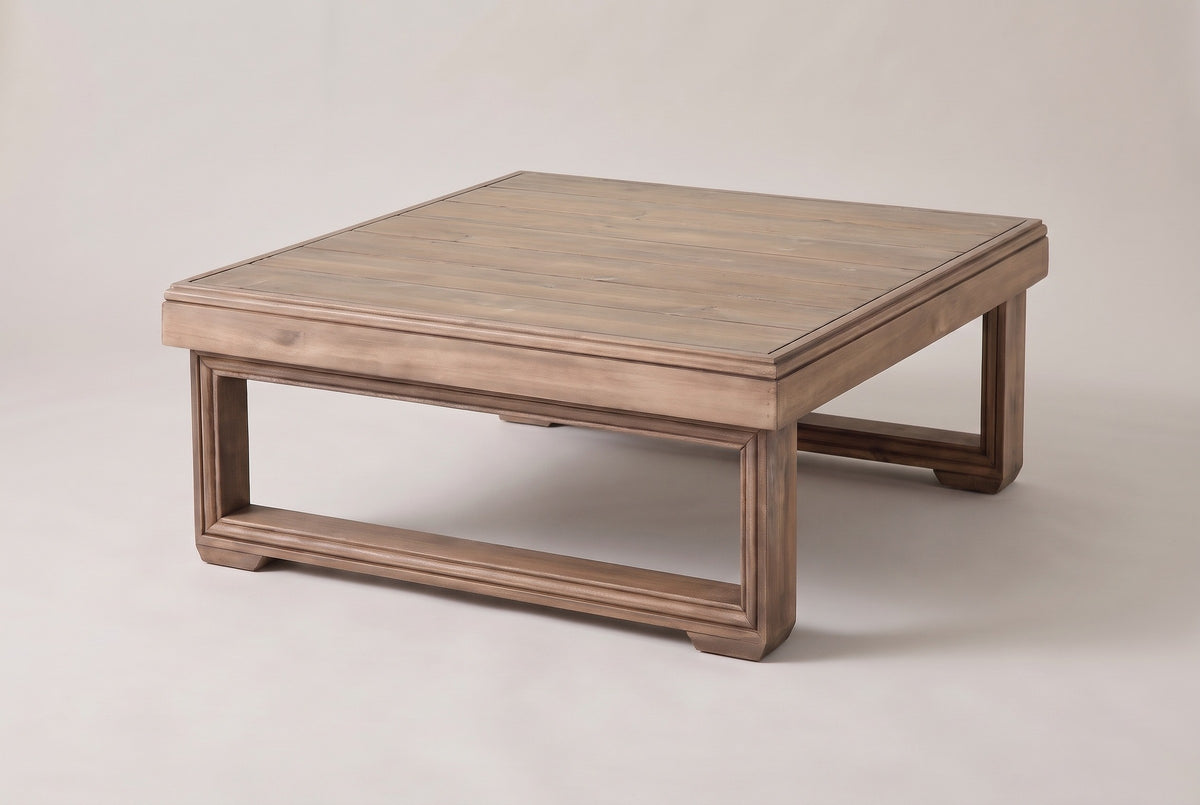 The Custonaci square acacia outdoor coffee table in a weathered brown finish, three-quarter view on a light studio backdrop
