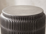 Close-up of the Cutigliano Cast Aluminum Carved Cylinder Side Table: the pewter top disc on the carved graphite collar