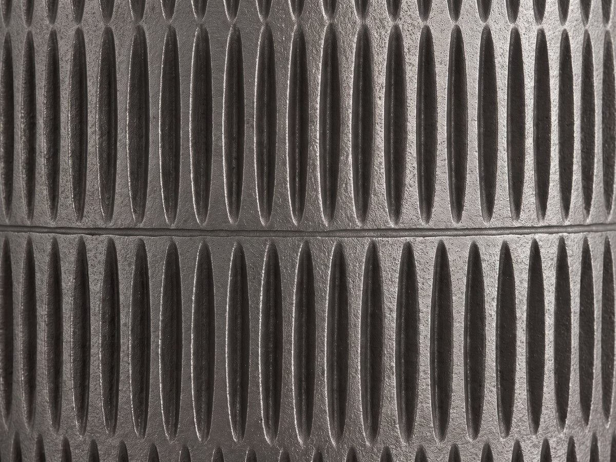 Close-up of the Cutigliano Cast Aluminum Carved Cylinder Side Table: the carved graphite cast aluminum body