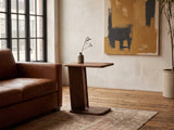 Cutrofiano Walnut Veneer C-Shaped Side Table beside a leather sofa in an industrial loft