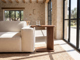 Cutrofiano Walnut Veneer C-Shaped Side Table beside a linen sofa in a poolside villa