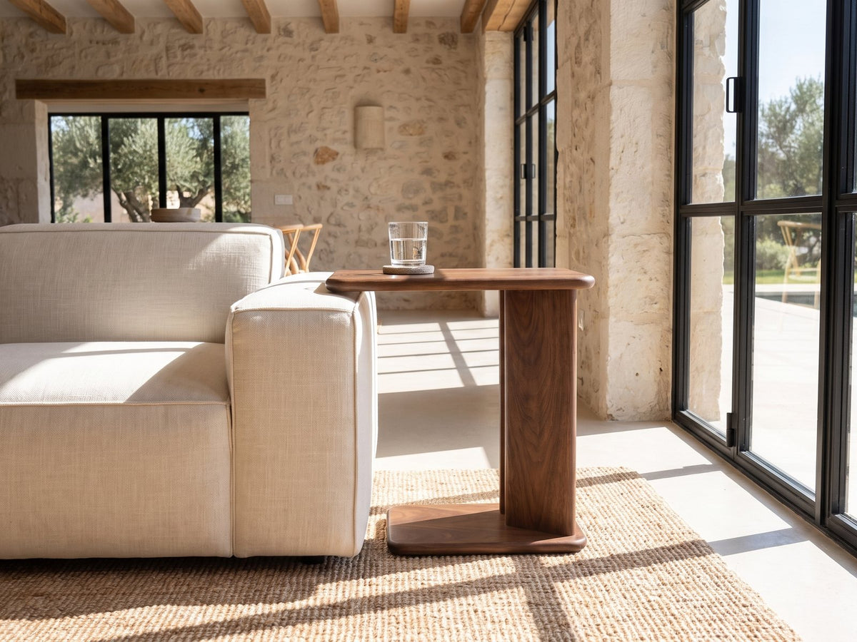 Cutrofiano Walnut Veneer C-Shaped Side Table beside a linen sofa in a poolside villa