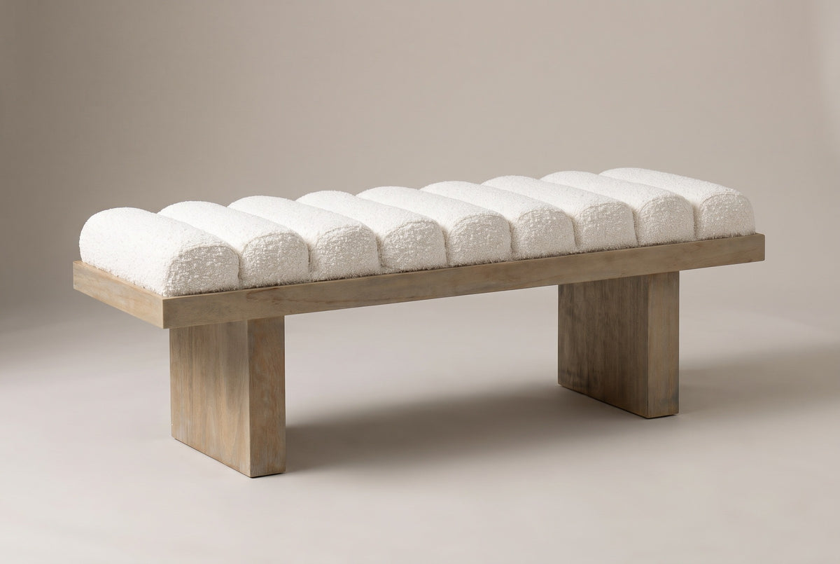 The Deruta bench in ivory white boucle on a wire-brushed wood frame, three-quarter view on a light studio backdrop