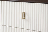 A fluted white drawer front of the Desulo nightstand with its small upright brass-finish pull