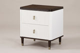 The Desulo two-drawer nightstand with a white fluted case, a dark walnut-tone top, brass-finish pulls and tapered legs with brass caps, three-quarter view on a light studio backdrop