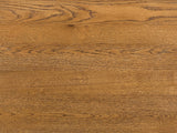Close-up of the Dogliani 42-Inch Round Walnut-Stained Oak Veneer Coffee Table: the walnut-stained oak veneer of the top