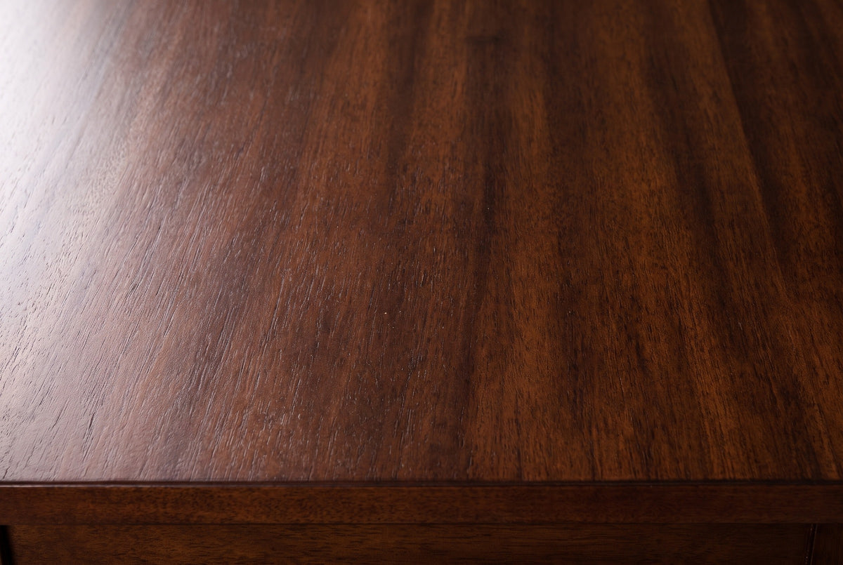 Close-up of the Dorgali nightstand top: Morocco Brown wood veneer with a fine striped figure and a soft sheen, with the square edge of the top below