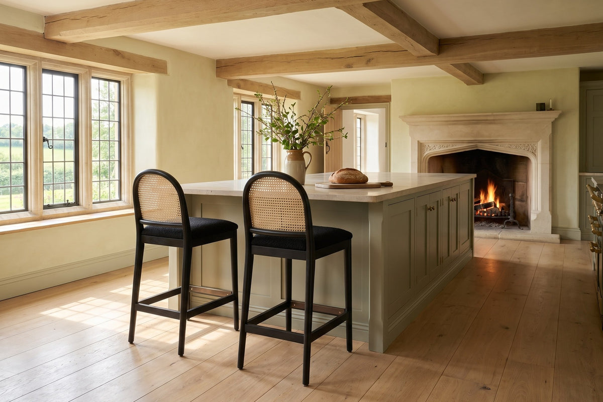 Drapia 26.5-Inch Cane-Back Ebony Oak Counter Stool, Black Boucle (Set of 2) in an English country dining room