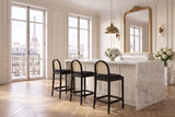 Drapia 26.5-Inch Cane-Back Ebony Oak Counter Stool, Black Boucle (Set of 2) in a Paris salon