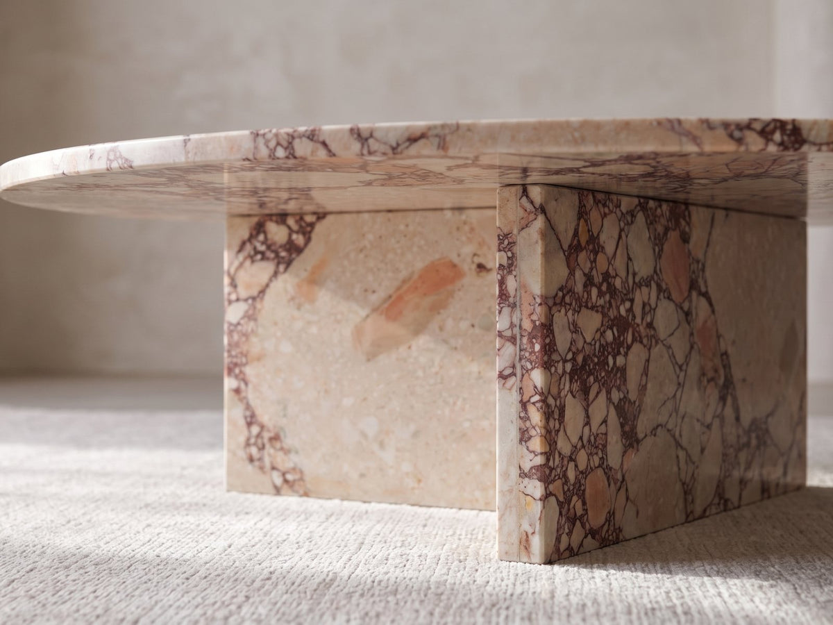 Close-up of the Elba Rosa Marble Coffee Table: the two rosa marble slabs set in a T under the top