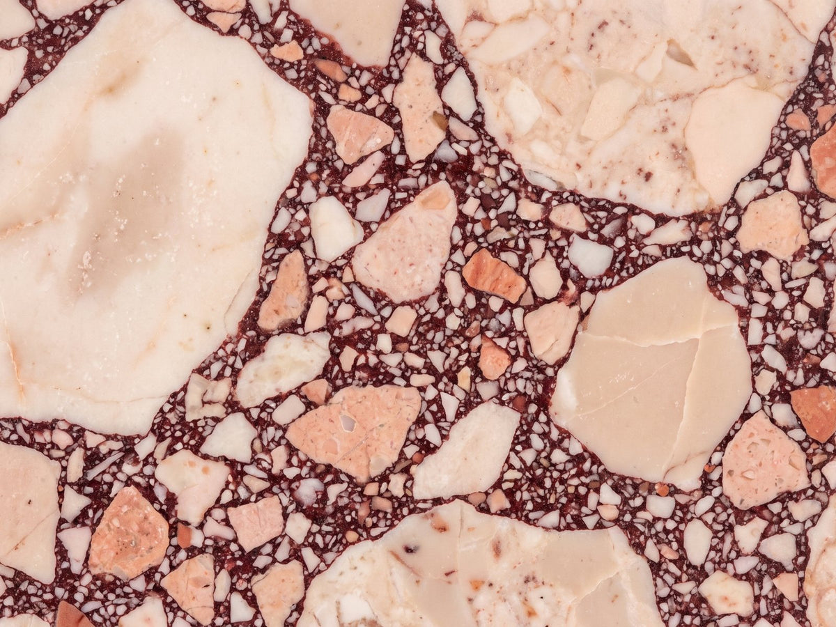 Close-up of the Elba Rosa Marble Coffee Table: the breccia veining of the polished rosa marble top