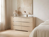 Este 66-Inch Light Elm 6-Drawer Dresser against a plaster wall under an abstract canvas in a bright bedroom