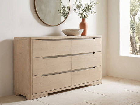 Este 66-Inch Light Elm 6-Drawer Dresser under a round bronze mirror in a villa bedroom
