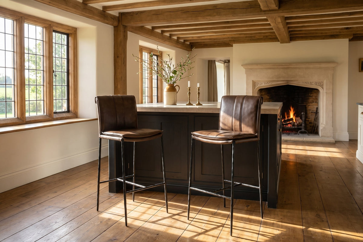 Falerna 30-Inch Top-Grain Leather Bar Stool with Hammered Iron Legs in an English country dining room