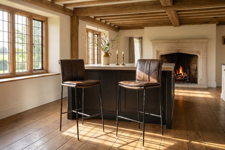 Falerna 30-Inch Top-Grain Leather Bar Stool with Hammered Iron Legs in an English country dining room