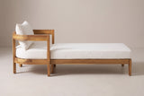 The Favignana chaise lounge seen from the side: the curved head end on the left and the long low frame on square legs