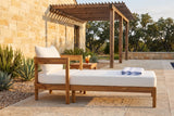Favignana acacia chaise lounge on a limestone terrace in the Texas Hill Country at golden hour, a cedar pergola and live oaks behind (side table not included)