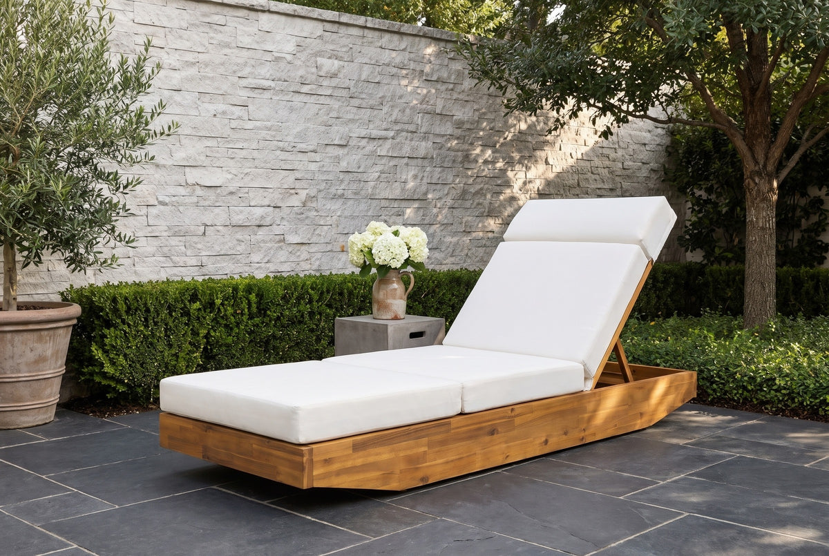 Ferla acacia chaise on a slate terrace in Dallas, Texas, with a pale stacked-stone wall, boxwood and an olive tree (side table not included)