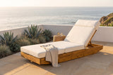 Ferla acacia chaise lounge on a sandstone terrace above the Pacific in La Jolla, a white plaster wall and blue agave behind (side table and throw not included)