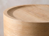 Close-up of the Ferrandina Natural Wood Veneer Drum Side Table: the dished top and its crisp rim over the veneered wall