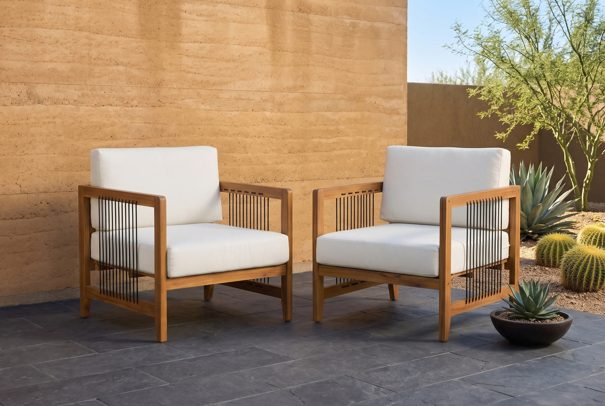 Two Ficarra acacia armchairs on dark slate pavers in front of an ochre rammed-earth wall, agaves and barrel cacti beside them (planter not included)