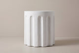 The Ficuzza side table seen straight from the side: a white cylinder with a plain top band and evenly spaced vertical flutes