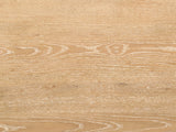 Close-up of the Fiesole Cerused Oak Veneer Round Pedestal Coffee Table: the cerused oak grain of the round top