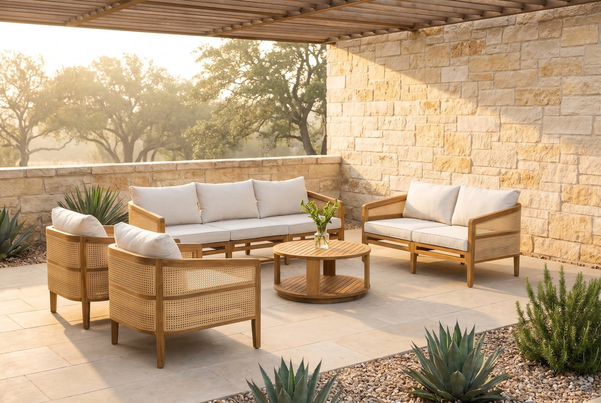 Filicudi five-piece acacia and rattan set on a limestone terrace in the Texas Hill Country at golden hour, a cedar pergola and live oaks behind (vase and plants not included)