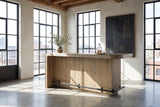 Firmo 78-Inch 2-Drawer Knotty Oak Veneer Counter-Height Home Bar with Footrest in a city loft