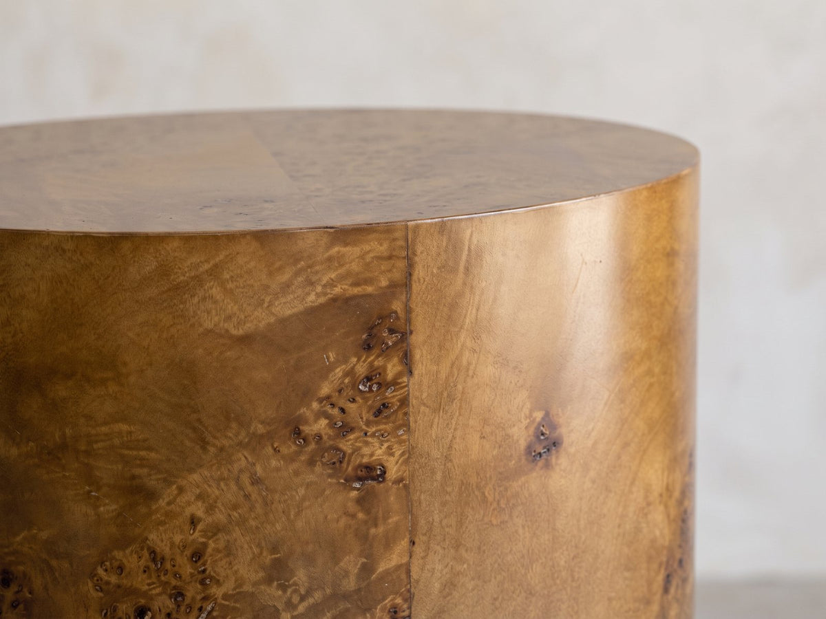 Close-up of the Fiumefreddo Walnut Burl Oval Pillar Side Table: the crisp edge where the oval burl top meets the side