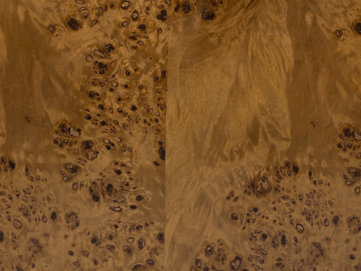 Close-up of the Fiumefreddo Walnut Burl Oval Pillar Side Table: the walnut burl veneer of the oval top