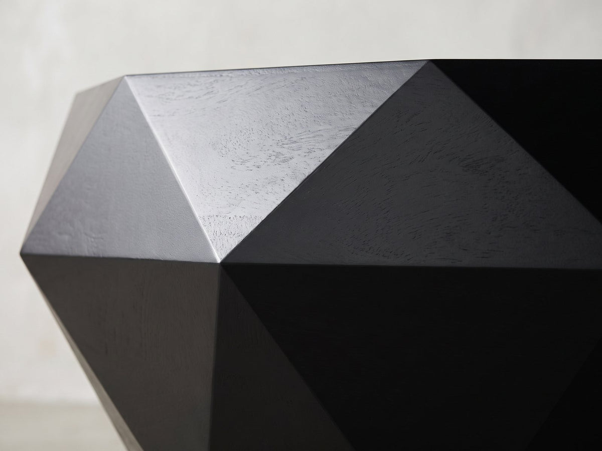 Close-up of the Follonica Faceted Acacia Coffee Table: two flat black facets meeting at the ridge
