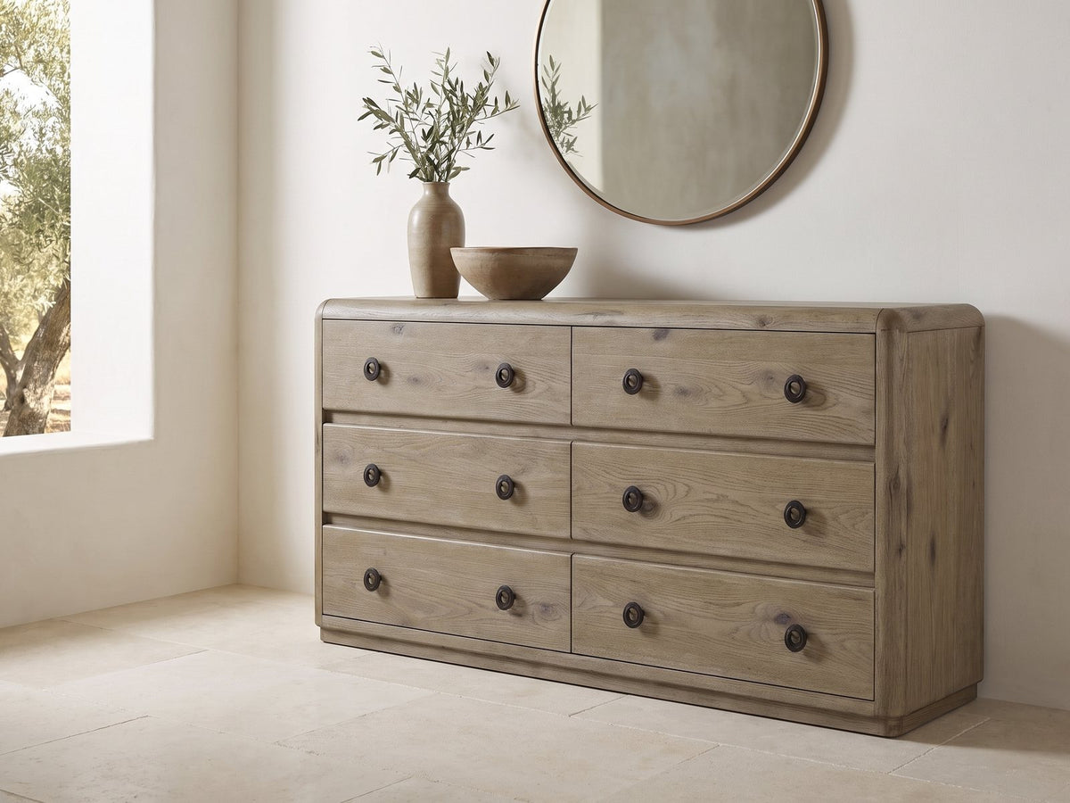 Fonzaso 66-Inch Weathered Knotty Oak 6-Drawer Dresser under a round bronze mirror in a villa bedroom