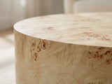 Close-up of the Fossano 31.5-Inch Round Burl Wood Veneer Pedestal Coffee Table: the crisp edge of the round top over the burl veneer drum
