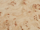 Close-up of the Fossano 31.5-Inch Round Burl Wood Veneer Pedestal Coffee Table: the pale burl wood veneer of the top