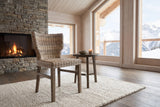 Frascineto Wingback Grey Rattan Dining Chair in an alpine chalet