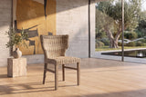 Frascineto Wingback Grey Rattan Dining Chair in a sunlit villa dining room